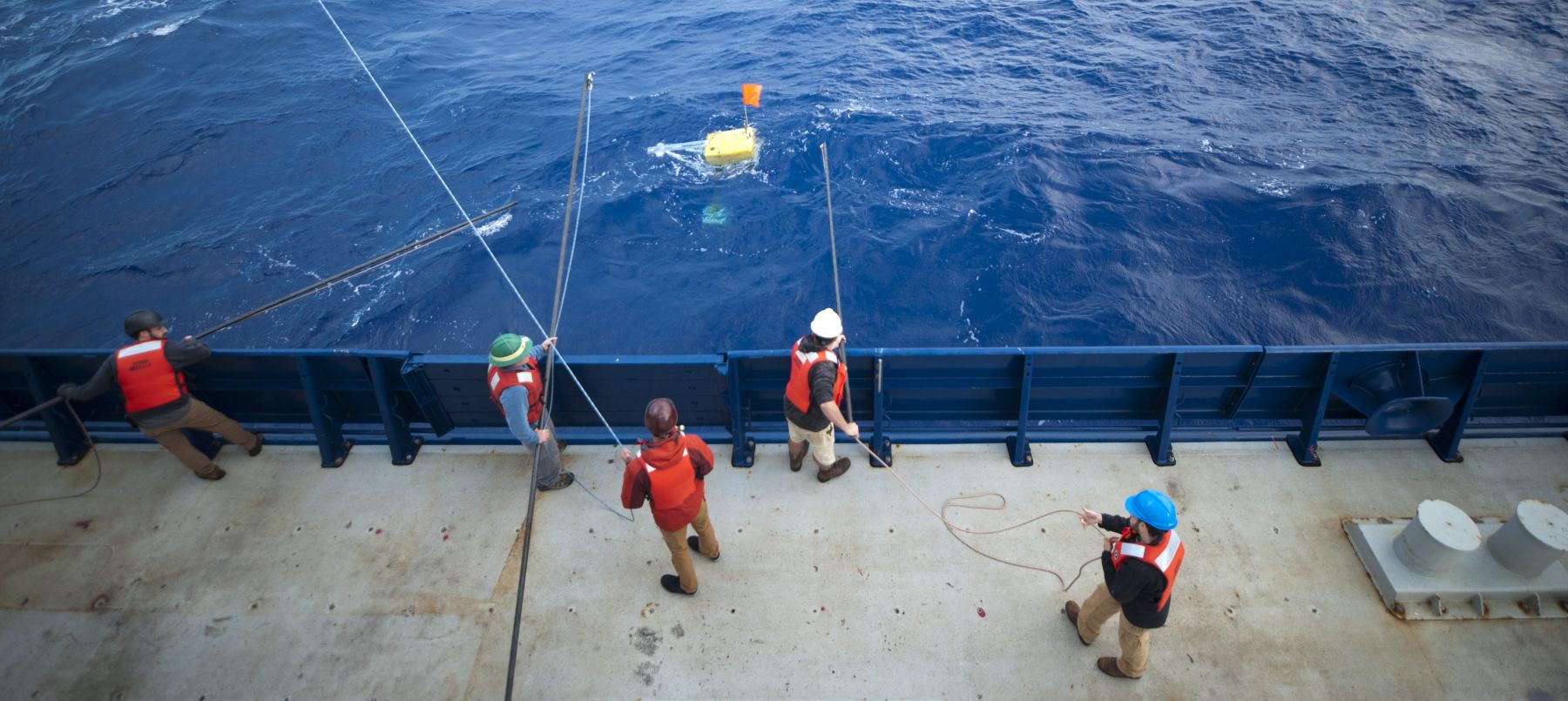 UCSB Marine Geophysicists prepare to recover an ocean bottom seismometer from the middle of the Pacific.